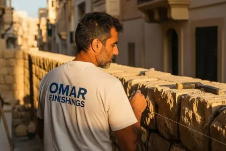 Skim coating a traditional Maltese limestone wall.