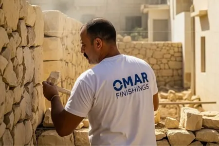 Expert plasterer in Malta working on a new wall.